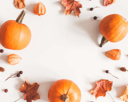 Autumn composition. Pumpkins, candles, dried leaves on white background. Autumn, fall, halloween...
