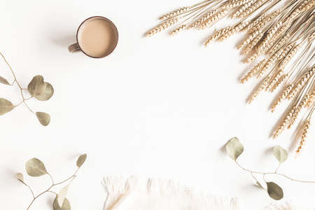Autumn composition. Dried flowers, plaid, cup of coffee on white background. Autumn, fall, thanksgiving day concept. Flat lay, top viewの写真素材