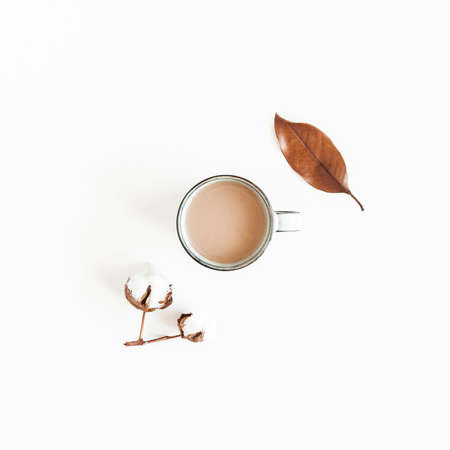 Autumn composition. Cup of coffee, leaf, cotton flowers on white background. Autumn, fall, winter...