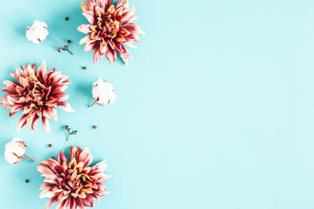 Autumn composition. Dried flowers and leaves on blue background. Autumn, fall, thanksgiving day concept. Flat lay, top viewの写真素材