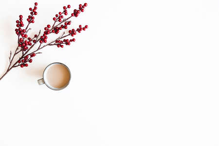 Autumn composition. Cup of coffee, berries on white background. Autumn, winter concept. Flat lay, top viewの写真素材