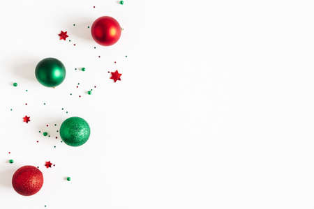 Christmas composition. Red and green decorations on white background. Christmas, winter, new year concept. Flat lay, top view, copy spaceの写真素材