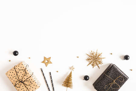 Christmas composition. Gift boxes, black and golden decorations on white background. Christmas,...