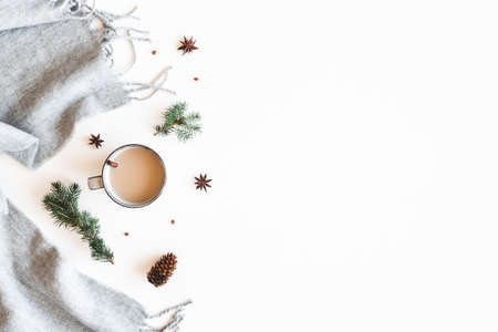 Christmas composition. Cup of coffee, fir tree branches, plaid on white background. Christmas, winter, new year concept. Flat lay, top viewの写真素材