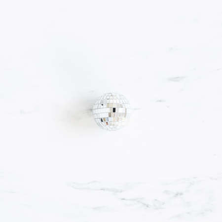 Christmas composition. Disco ball on marble background. Christmas, winter, new year concept. Flat lay, top viewの写真素材