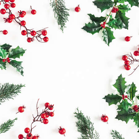 Christmas composition. Frame made of christmas plants on white background. Flat lay, top view, copy spaceの写真素材
