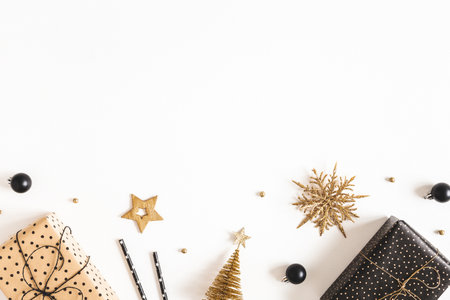 Christmas composition. Gift boxes, black and golden decorations on white background. Christmas, winter, new year concept. Flat lay, top view, copy spaceの写真素材