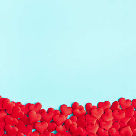 Valentine's Day background. Red hearts on blue background. Valentines day concept. Flat lay, top...
