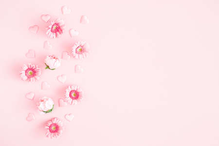 Valentine's Day background. Pink flowers, hearts on pastel pink background. Valentines day concept. Flat lay, top view, copy spaceの写真素材