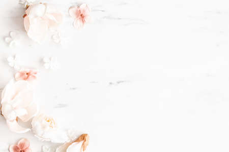 Flowers composition. White and pink flowers on marble background. Flat lay, top viewの写真素材