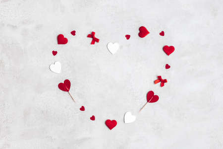 Valentine's Day background. Red and white hearts on concrete gray background. Valentines day concept. Flat lay, top viewの写真素材