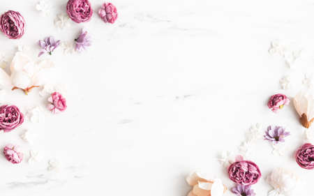 Flowers composition. White and purple flowers on marble background. Flat lay, top viewの写真素材