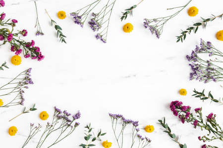 Flowers composition. Colorful flowers and eucalyptus leaves on marble background. Flat lay, top viewの写真素材