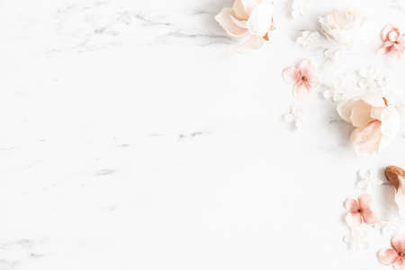 Flowers composition. White and pink flowers on marble background. Flat lay, top viewの写真素材