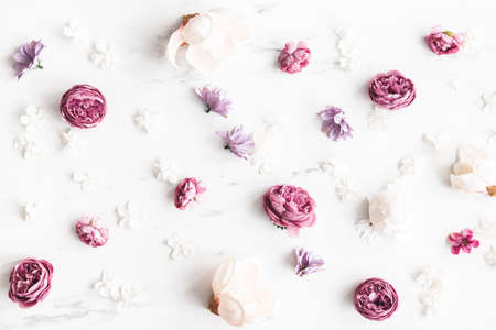 Flowers composition. White and purple flowers on marble background. Flat lay, top viewの写真素材