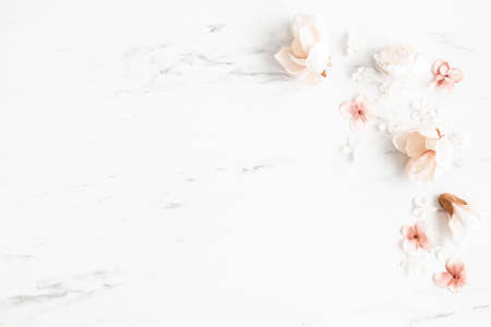 Flowers composition. White and pink flowers on marble background. Flat lay, top viewの写真素材