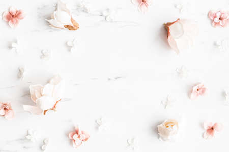Flowers composition. White and pink flowers on marble background. Flat lay, top viewの写真素材
