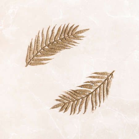 Christmas composition. Golden leaves onmarble beige background. Christmas, winter, new year concept. Flat lay, top view, copy spaceの写真素材