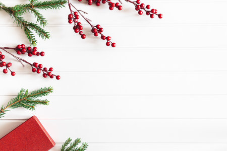 Christmas composition. Christmas gift, fir tree branches on white background. Flat lay, top view, copy spaceの写真素材