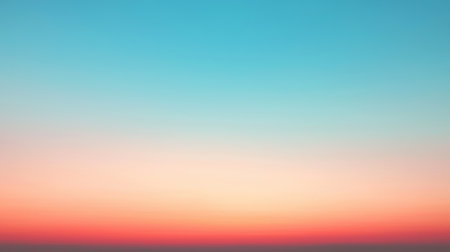 A serene sky at dawn featuring a soft gradient of pastel colors, transitioning smoothly from light blue to pink and orange. The subtle hues create a peaceful and calming effect.の素材
