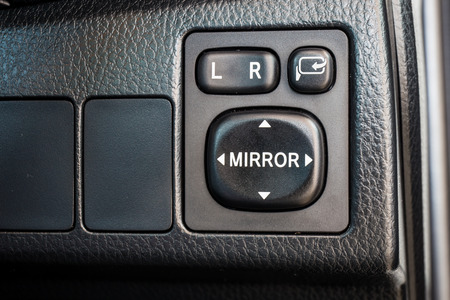 Switch button adjust or controls side mirrors in a car