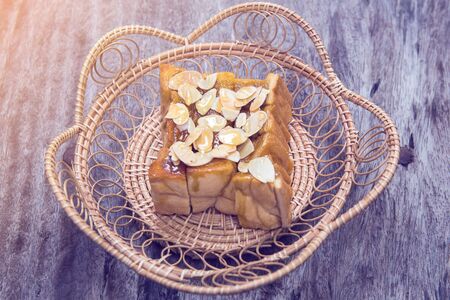 toast or bread pour honey with pumpkin seeds on wood table