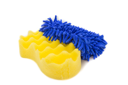 Yellow sponges and blue mitts for washing car on white backgroundの写真素材