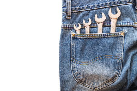 chrome lug wrench in back blue jeans pocket on white isolated background. Copy space for textの写真素材