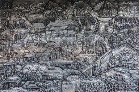 Abstract art of tradition lifestyle carve on silver metal frame in temple at Wat Sri Suphan Chiang Mai, Thailandの写真素材