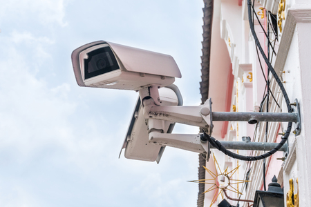 Closed Circuit Television camera isolated on white building background. Selective Focus