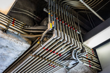 Odd angles of electrical conduits captured in black and white. Taken in an industrial building or architecture.の写真素材