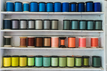 Colorful sewing thread/Sewing thread which is arranged on shelf.の写真素材