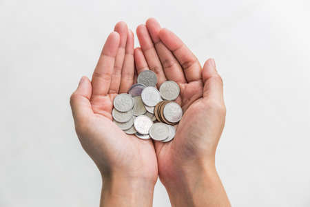 Japanese yen coins in woman hand on white backgroundの写真素材