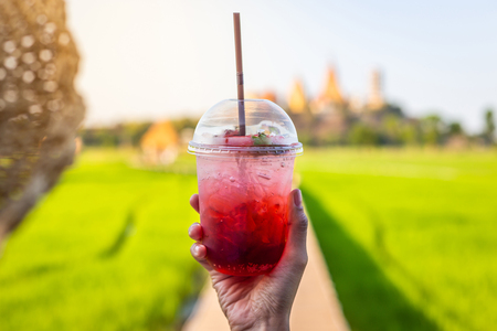 Happy girl hands holding cocktails or strawberry soda in summer season at outdoor relax timeの写真素材
