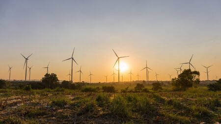 Wind energy turbines in the midst of nature, gorge and trees in sunset time, Energy generator nature...