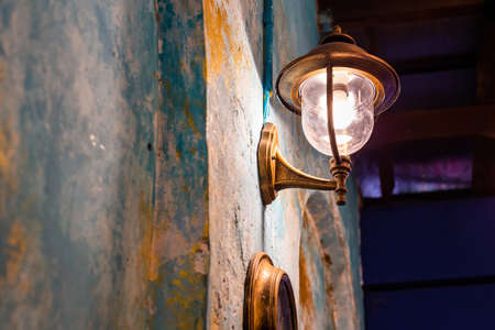 Old lamp on a cement wall at night. Copy space backgroundの写真素材