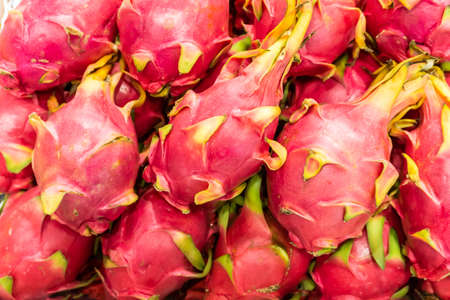 Many fresh dragon fruit lined up in the background.Many fresh dragon fruit lined up in the...
