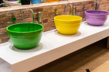 Colorful wash basin or sinks with modern water discharge sensors.の写真素材