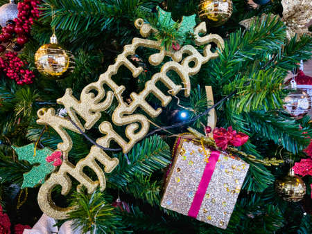 Christmas tree decorated with multicolored balls and snowmen with Happy new year signs and...