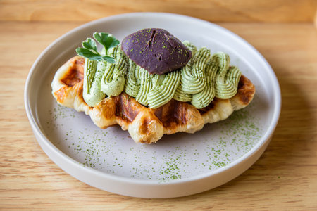 Green tea waffles in a white plate on a Japanese traditional wooden tray.の写真素材