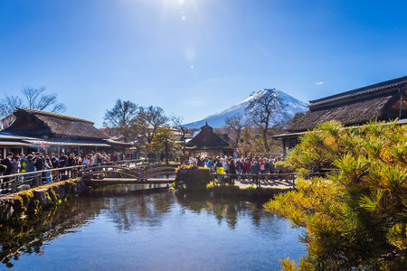 Oshino, Japan - November 14, 2023:Tourists visit Oshino Hakkai with Fuji mount background, a small village in the Lake region with 8 ponds, located between Lake Kawaguchiko and Yamanakako.のeditorial素材