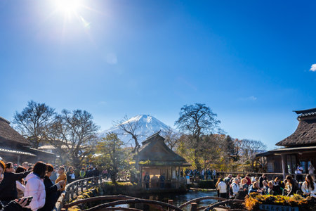 Oshino, Japan - November 14, 2023:Tourists visit Oshino Hakkai with Fuji mount background, a small village in the Lake region with 8 ponds, located between Lake Kawaguchiko and Yamanakako.のeditorial素材