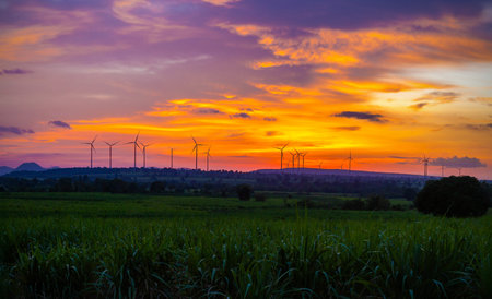 Landscape Panorama of Windmill on a mountain with vast meadows at sunset, beautifully illuminated.