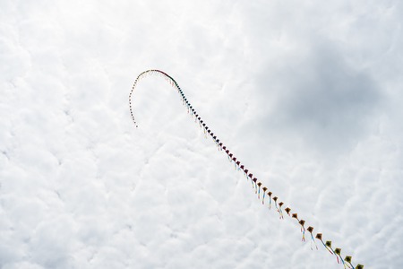 Kites flying in the sky among the clouds.Kite Festival