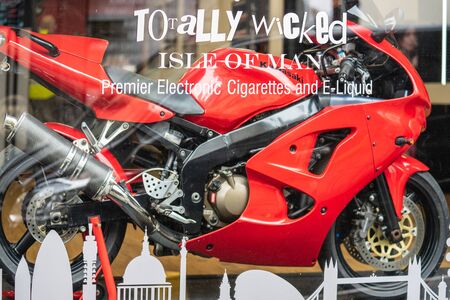 Douglas, Isle of Man, June 16, 2019. The motorcycle in a show-window of shop.