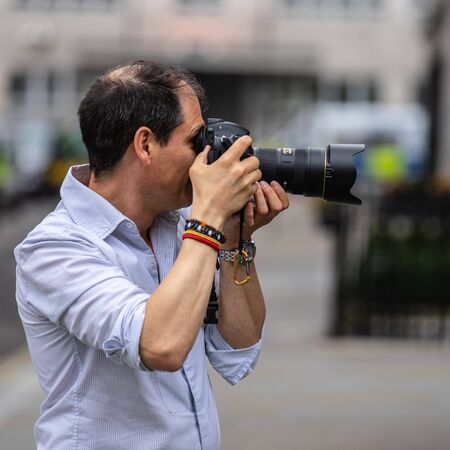 London, UK, July 14, 2019. Photographer taking pictures of sporty models near Polo Ralph Lauren...