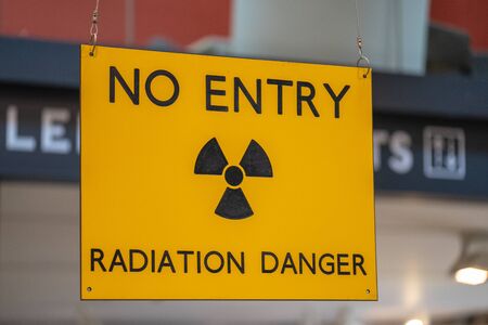 Yellow radiation warning and hazard sign forbidding entry to a radioactive zoneの写真素材