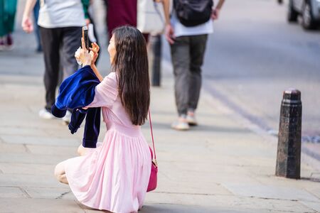 Cambridge, UK, August 1, 2019. Turists walking down and taking pictures at the street of Cambridge on a busy sunny day in front of Kings Collegeのeditorial素材