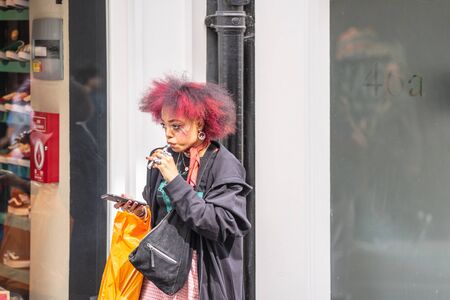 London, UK, July 14, 2019. Woman Vaping An electronic cigarette or e-cigarette, is a handheld battery-powered vaporizerのeditorial素材