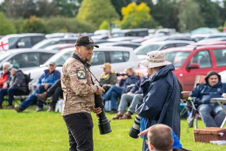 OLD WARDEN, BEDFORDSHIRE, UK, OCTOBER 6, 2019. Photographer shooting at an air show.Race Day at...